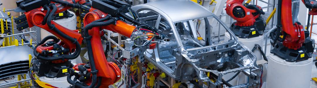 Automated assembly line robots meticulously constructing a vehicle, showcasing the intricate collaboration of mechanical systems, akin to the precision of fluid control systems in modern vehicles