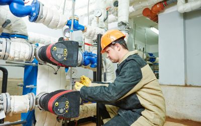 Technician performing maintenance on steam solenoid valves to ensure operational reliability in a food processing plant.